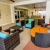 a room with a couch and chairs