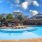 resort style pool with tanning shelf and patio