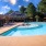resort style pool with tanning shelf and patio